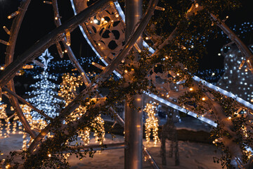 Kyiv, Ukraine - January 3, 2024: New Year location in Kyiv. Christmas tree made of lights, deer and bears. people come to the rink with friends and families