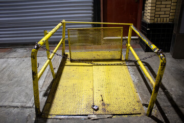 Closed metal gate with chains padlocked in the darkness of night in New York, Manhattan