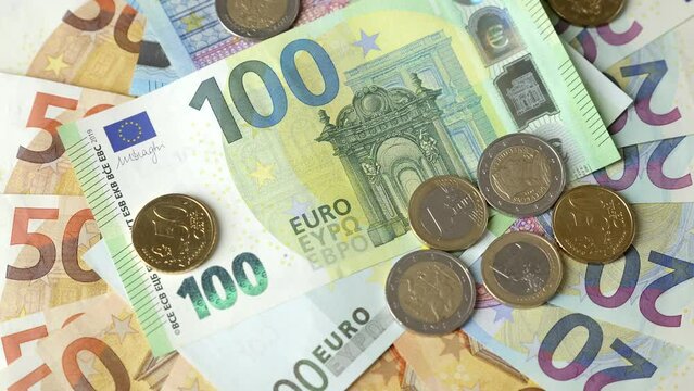 Euro banknotes and coins background, top view