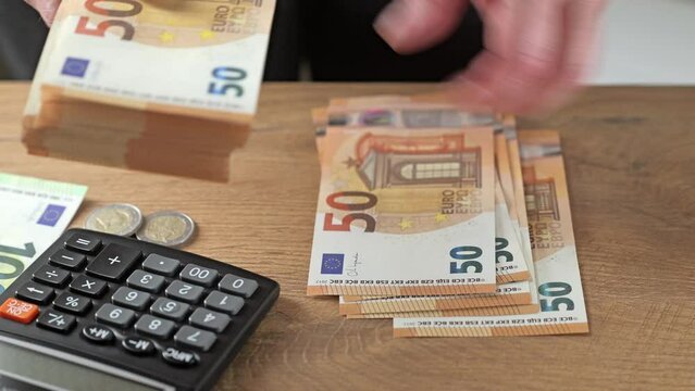 Counting  50 euro banknotes in hands