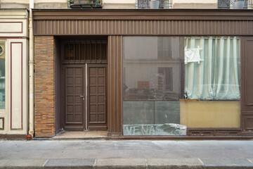 old parisian storefront facade painted in brown , commercial boutique vitrine template