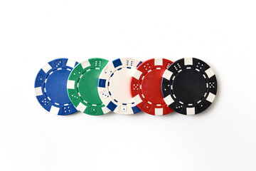 Detail of five different colored gambling game chips isolated white