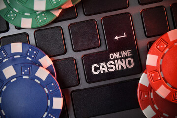 Online casino concept with keyboard and chips