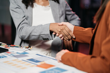 designer team shake hands confidently professional investor working with new startup project at an...