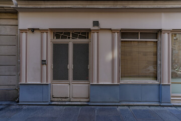 Fototapeta na wymiar beige and grey french boutique facade , parisian storefront template , vintage shop entrance door