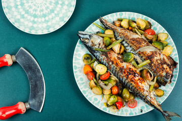 Grilled mackerel fish with vegetables.