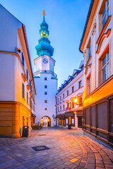 Bratislava, Slovakia. A street in the Old Town leading to Michael's Gate tower. - obrazy, fototapety, plakaty