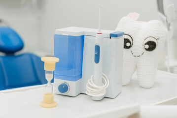 A plush tooth and an irrigator in the dentist's office.