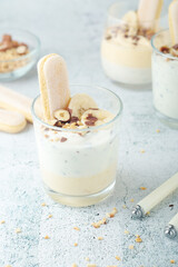 Milk mousse dessert with nuts in glasses