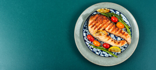 Grilled trout steak on a plate.