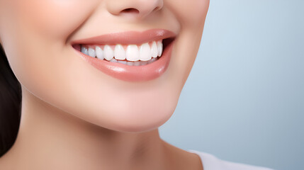 Close - up cropped of a beautiful smiling  woman with white perfect teeth isolated on blue studio background with copy space. Dental care. Stomatology. Dentistry concept.