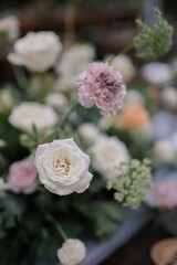 Conceptual decoration for special event. Gathering. Family dinner. Private party. Celebration. Table flower. Long table. Table Setting. With drop light. Outdoors. Details. 