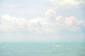 A tropical sea, and a cloudy sky on a bright, summers day.  The view is from Key West, the...