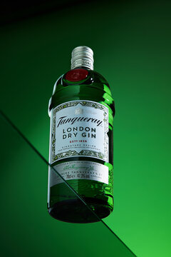 Bottle of Tanqueray export strength London dry gin bottom view on green gradient background, Kyiv, Ukraine. November 8, 2023
