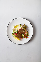 Mediterranean Inspired Vegan Falafel Meal with Lemon and Greens, Restaurant Presentation