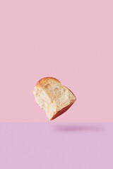Flying Slice of White Bread on Pink and Purple Background