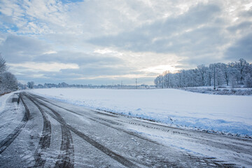 Fototapeta na wymiar Road in winter landscape in Hassleholm, Sweden
