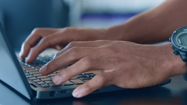 Close up on man hands typing on a keyboard 