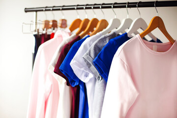 Colorful clothes hanging on rack in room