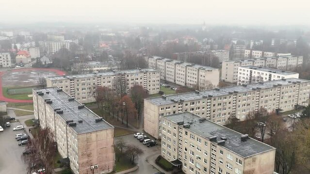 Urban background in a gloomy day. Exterior of an old apartment buildings. Soviet design of high-rise building of a small city in Europe. Silute. Lithuania.