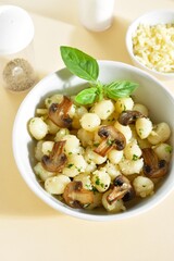 Potato gnocchi with mushroom, parmesan cheese and greens