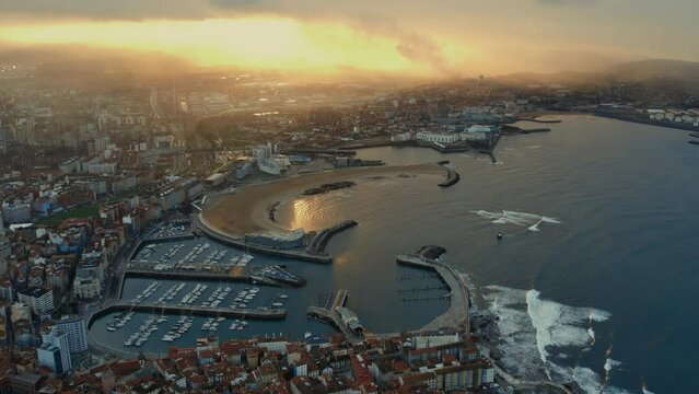 Drone point of view Gijon or Xixon city in north-western Spain during sunset, coast of Cantabrian Se, Bay of Biscay, in the central-northern part of Asturias. Travel destinations, landmarks concept