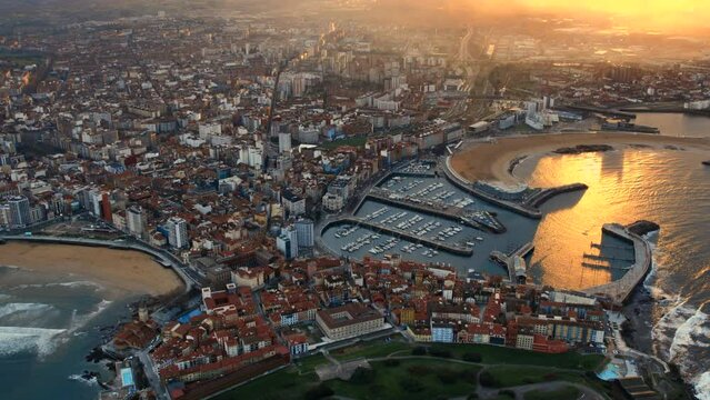 Drone point of view Gijon or Xixon city in north-western Spain during sunset, coast of Cantabrian Se, Bay of Biscay, in the central-northern part of Asturias. Travel destinations, landmarks concept
