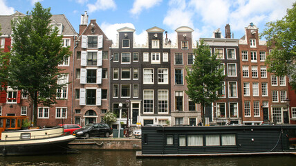 Obraz premium façades de maisons flamandes typiques en briques le long d'un canal à Amsterdam aux Pays Bas