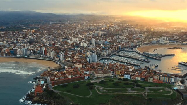Drone point of view Gijon or Xixon city in north-western Spain during sunset, coast of Cantabrian Se, Bay of Biscay, in the central-northern part of Asturias. Travel destinations, landmarks concept