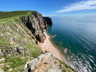 The beautiful Southeastern coast of the island of Shkota in August in sunny weather. Russia,...