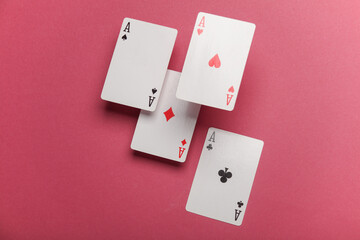 Four aces on a pink background