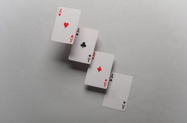 Four aces on a gray background