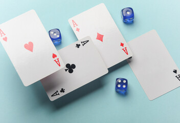 Four aces and dice on a blue background