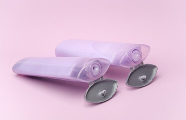 Shampoo bottles on purple pastel background