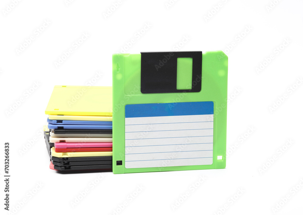 Aufkleber green and stack of colored floppy disks on white background