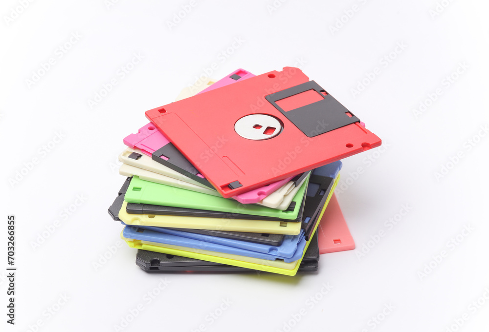 Poster stack of colored floppy disks on white background