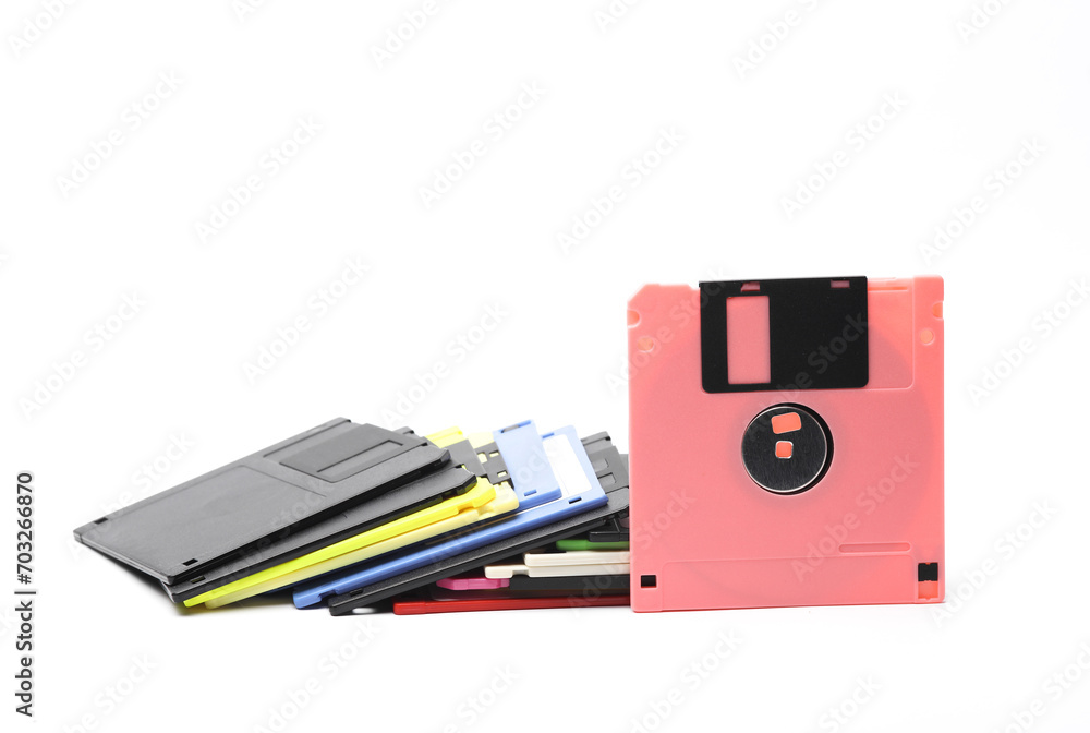 Aufkleber pink and stack of colored floppy disks on white background
