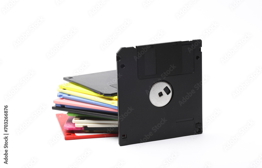 Poster black and stack of colored floppy disks on white background