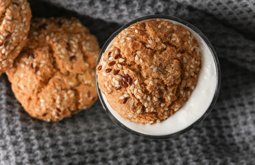 Cereal cookies in yogurt glass on gray fabric blanket