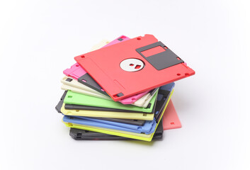 Stack of colored floppy disks on white background