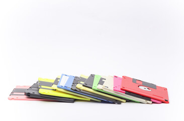 Stack of colored floppy disks on white background