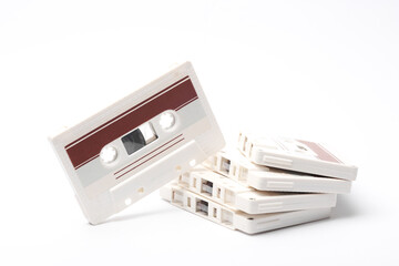 Stack of retro 80s audio cassettes on white background