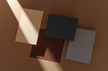 Set of colored floating blank card sheets with shadow on brown background. Minimalism business...