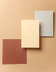 Fototapeta premium Set of colored floating blank card sheets with shadow on brown background. Minimalism business brand template, creative layout