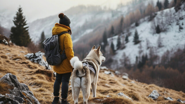 Close-up young trekking with Siberian husky dog on the mountain