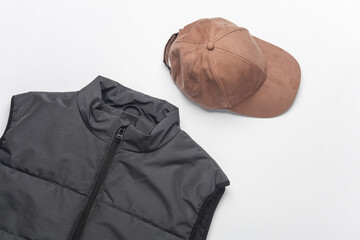 Men's sleeveless down jacket with cap on a white background. Flat lay
