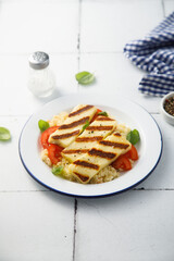 Grilled halloumi cheese with couscous and vegetables