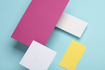 Group of floating colored blank cards sheet with shadow on blue background. Minimalism business brand template, creative layout