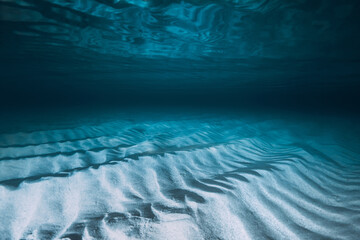 Tropical transparent blue ocean with sandy bottom. Panoramic underwater view with artificial light