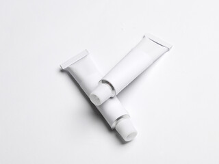 White empty tubes of acrylic or oil paint for creativity on white background. Template for design,...